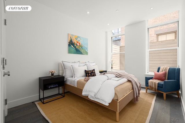 bedroom featuring wood finished floors, recessed lighting, and baseboards