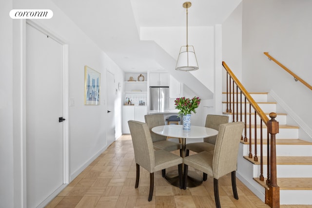 dining room featuring visible vents, baseboards, and stairs