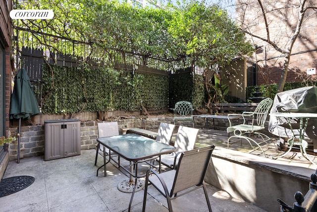 view of patio / terrace featuring outdoor dining area and a grill