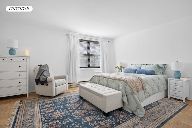 bedroom with a baseboard radiator and visible vents