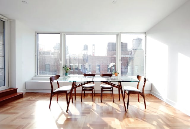 dining room with a city view and baseboards