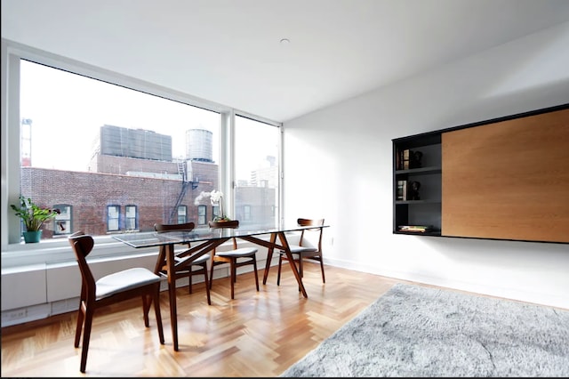 dining area featuring baseboards and a city view