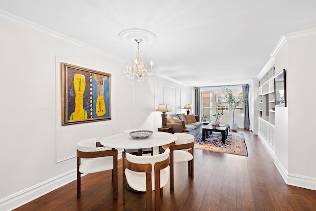 305 E 24th St Unit 5F, New York City, NY 10010 - dining room featuring a chandelier, dark wood-style flooring, crown molding, and baseboards