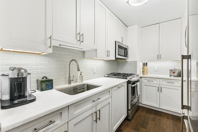 305 E 24th St Unit 5F, New York City, NY 10010 - kitchen with appliances with stainless steel finishes, a sink, light countertops, and white cabinets