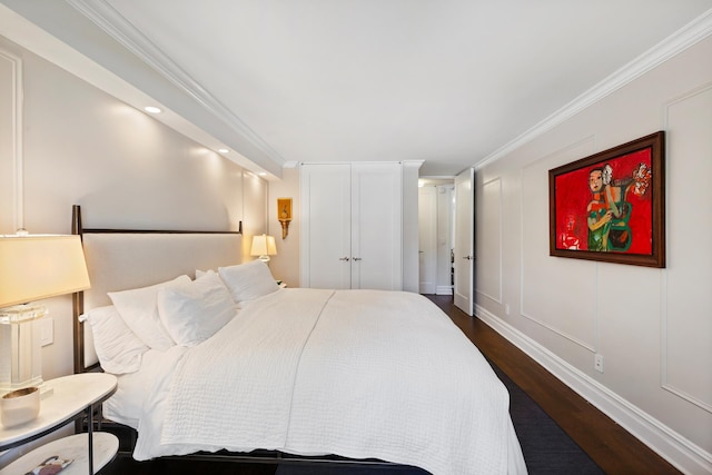 305 E 24th St Unit 5F, New York City, NY 10010 - bedroom with dark wood-type flooring, ornamental molding, and a decorative wall