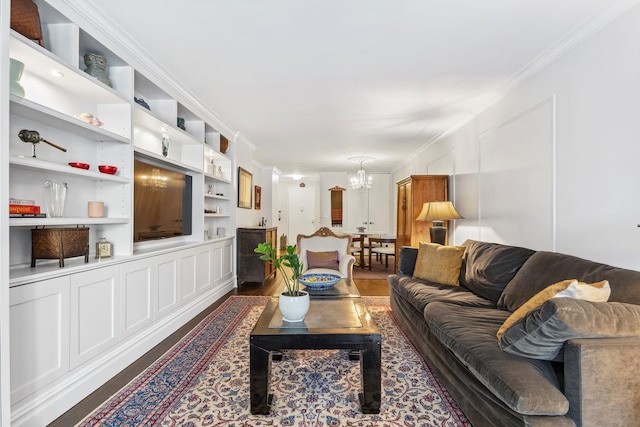 living room with dark wood finished floors, crown molding, built in shelves, and an inviting chandelier