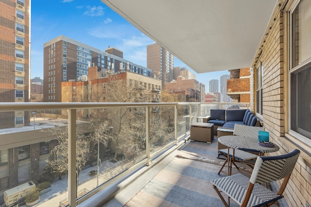 balcony featuring a view of city and outdoor lounge area