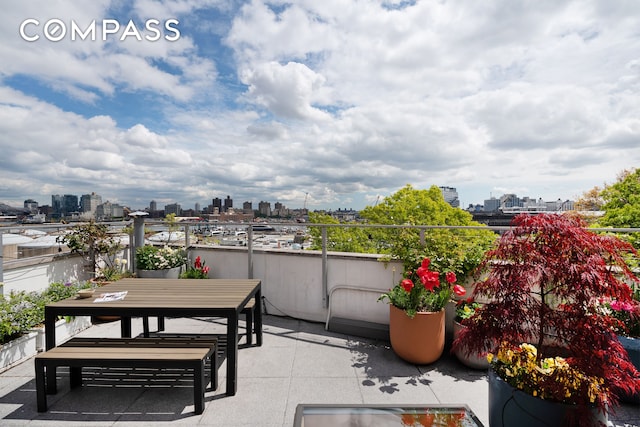 balcony featuring a city view, a patio, and outdoor dining space