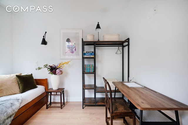 home office with baseboards and light wood-style floors