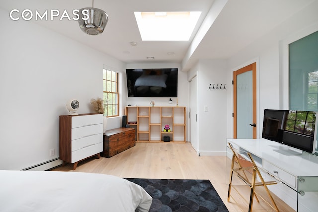 bedroom featuring baseboards, a baseboard radiator, wood finished floors, and multiple windows