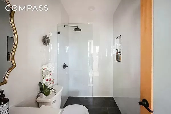 full bathroom with walk in shower and toilet