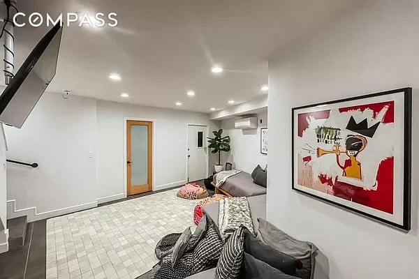 playroom with baseboards, a wall unit AC, and recessed lighting