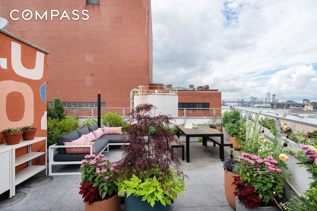 balcony featuring a view of city and outdoor dining space