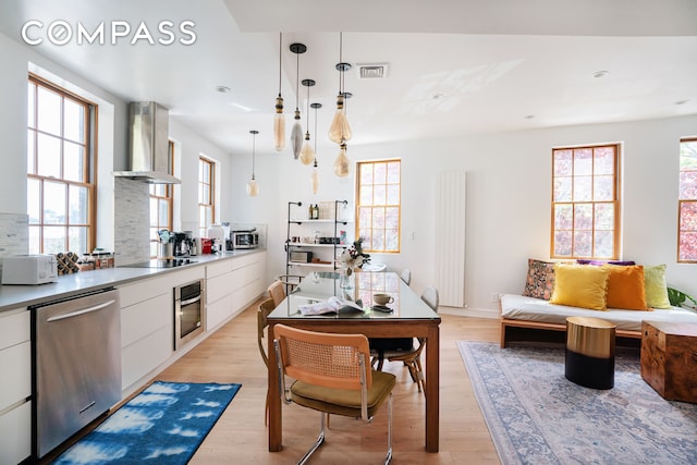 kitchen featuring visible vents, white cabinetry, appliances with stainless steel finishes, and extractor fan