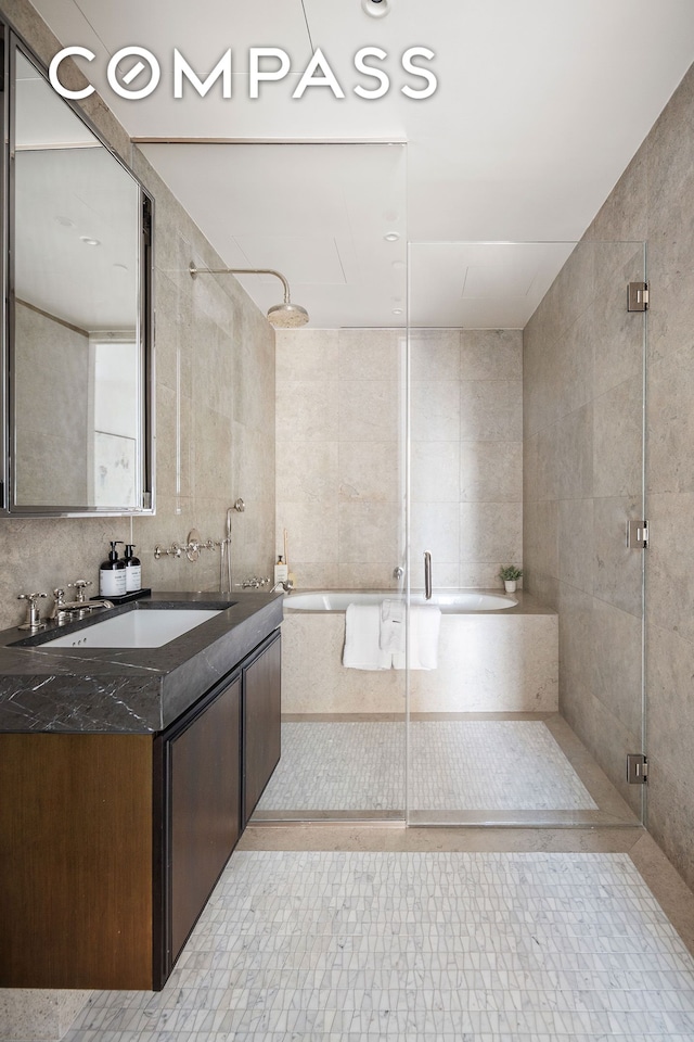 5 Beekman St Unit 21B, New York City, NY 10038 - full bath featuring a stall shower, tile walls, a tub, vanity, and tile patterned floors