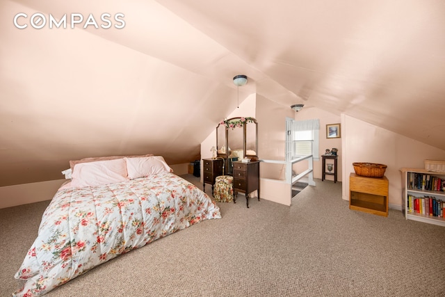 carpeted bedroom featuring lofted ceiling