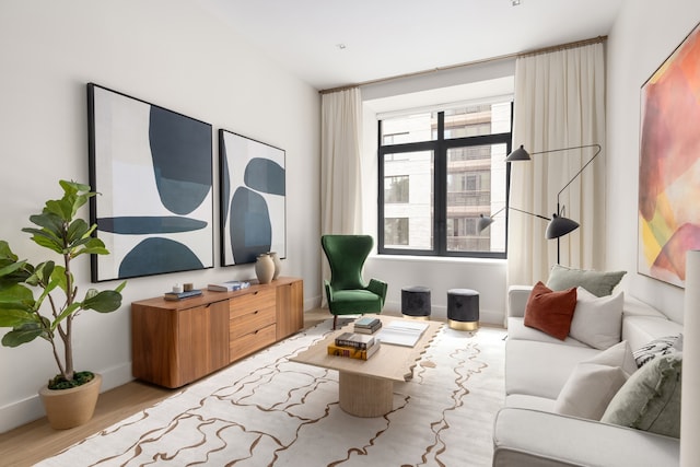 living area featuring baseboards and wood finished floors