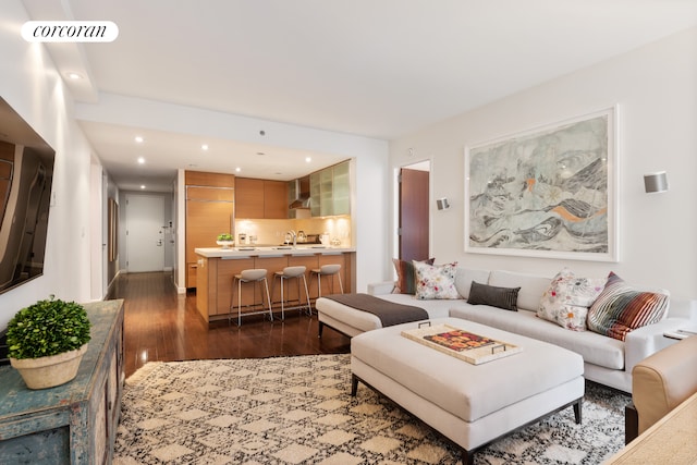 living area featuring recessed lighting, visible vents, and dark wood finished floors