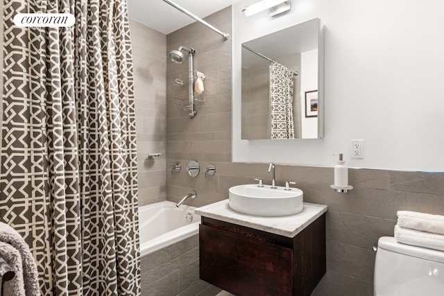 462 W 58th St Unit 1A, New York City, NY 10019 - full bath with tile walls, tiled shower / bath, toilet, and vanity