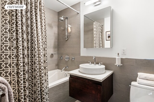 462 W 58th St Unit 1A, New York City, NY 10019 - full bathroom with vanity, tiled shower / bath combo, and tile walls