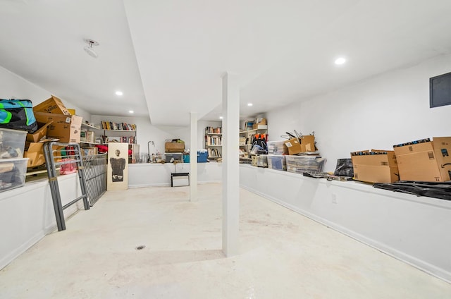 finished basement with baseboards and recessed lighting