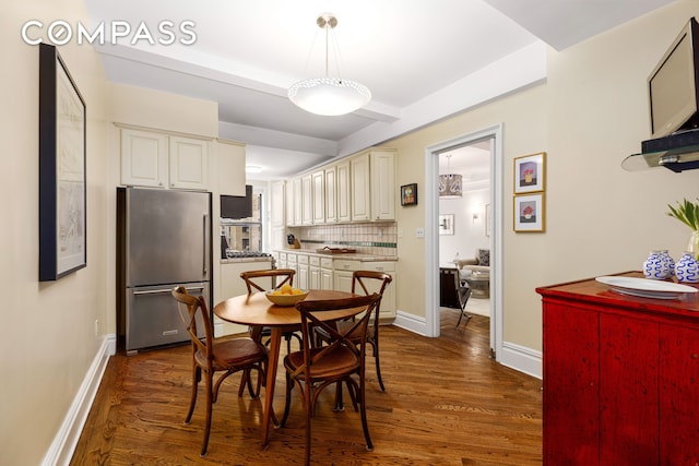 dining space with dark wood finished floors and baseboards