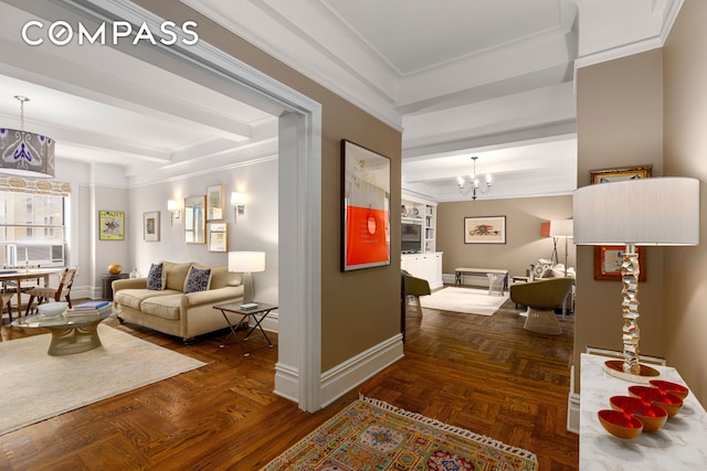 corridor featuring beam ceiling, crown molding, baseboards, and a chandelier