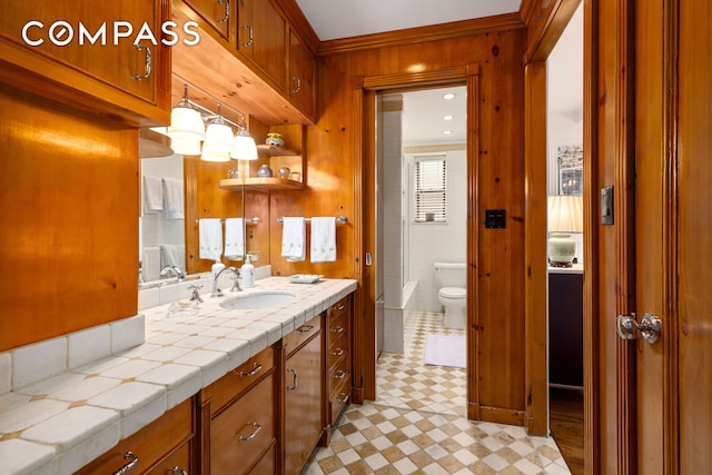 full bathroom featuring tile patterned floors, toilet, crown molding, walk in shower, and vanity