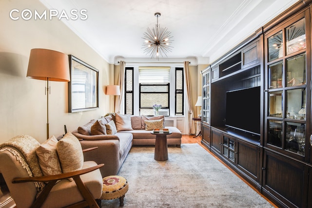 living room with an inviting chandelier, crown molding, and light wood finished floors