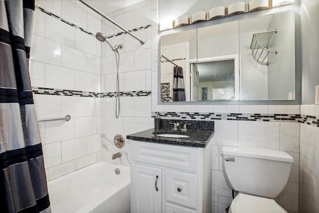 bathroom with vanity, tile walls, toilet, and shower / tub combo with curtain