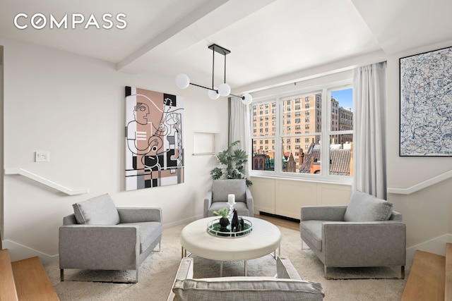 living room featuring beam ceiling and baseboards