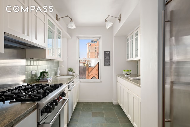 kitchen with range hood, high quality appliances, a sink, glass insert cabinets, and white cabinetry