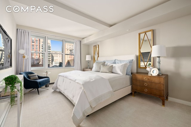 bedroom featuring baseboards and light carpet