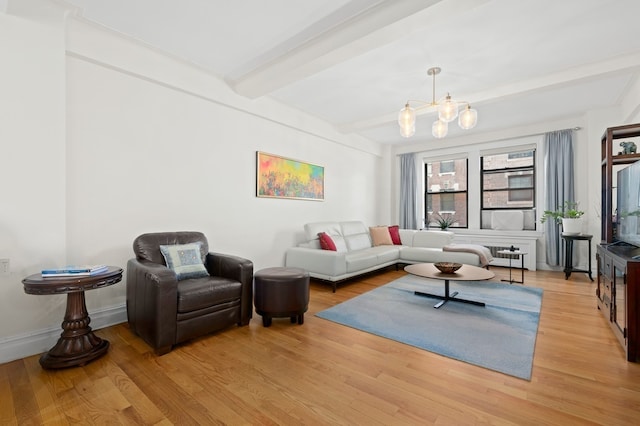 living room featuring beam ceiling, a notable chandelier, wood finished floors, and baseboards