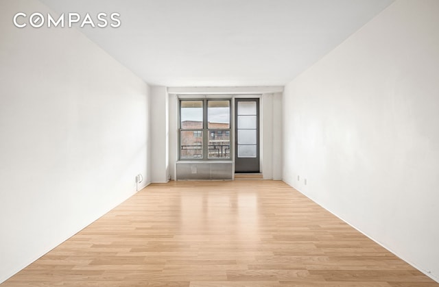 spare room featuring light wood-style floors