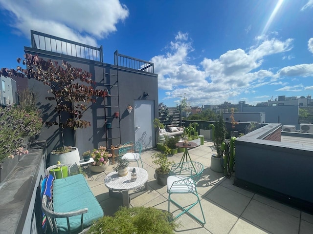 balcony with a patio area and a city view