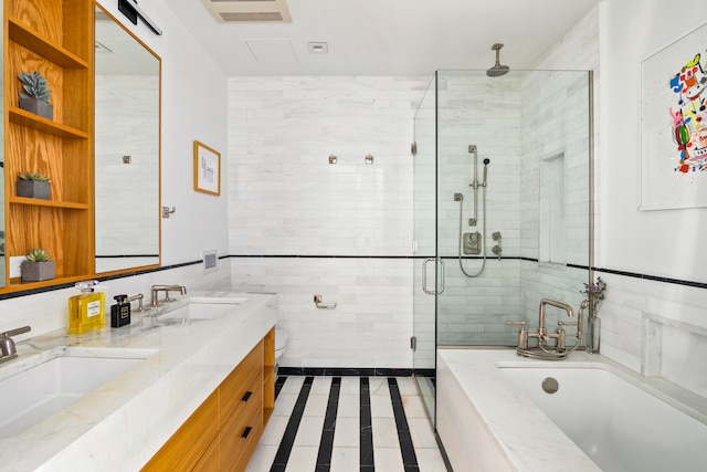 bathroom with tile walls, a stall shower, tile patterned flooring, a bathtub, and double vanity