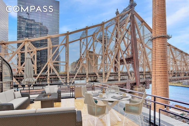 40 Sutton Pl Phm, New York City, NY 10022 - view of patio with a water view and an outdoor living space with a fire pit