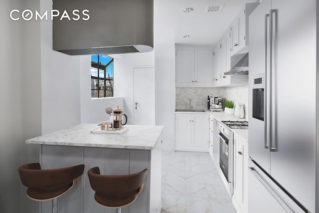 40 Sutton Pl Phm, New York City, NY 10022 - kitchen with a sink, marble finish floor, visible vents, extractor fan, and stainless steel fridge with ice dispenser