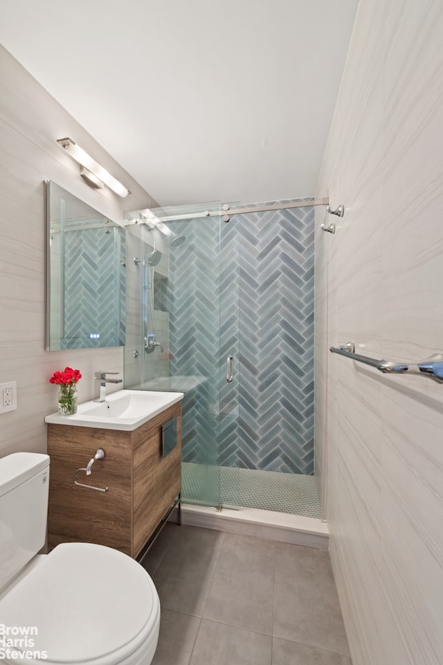 bathroom with tile patterned floors, toilet, a shower stall, and vanity