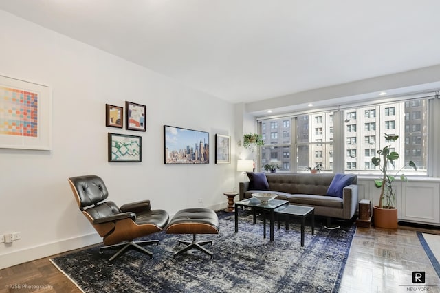 living area featuring baseboards