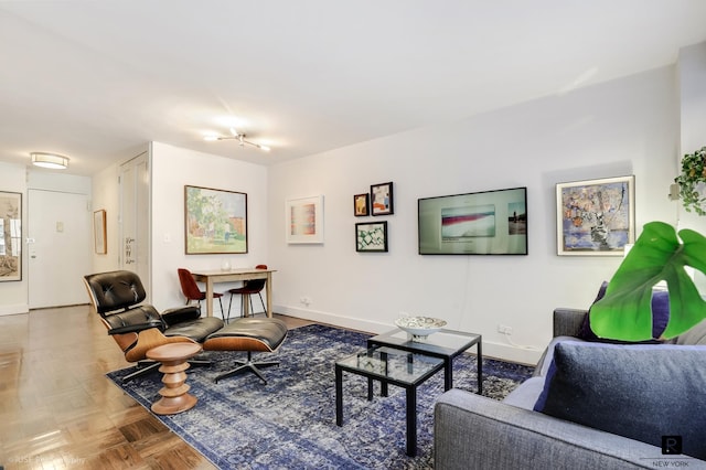 living area featuring baseboards