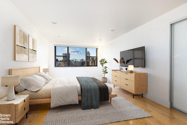 bedroom with light wood finished floors, recessed lighting, and baseboards