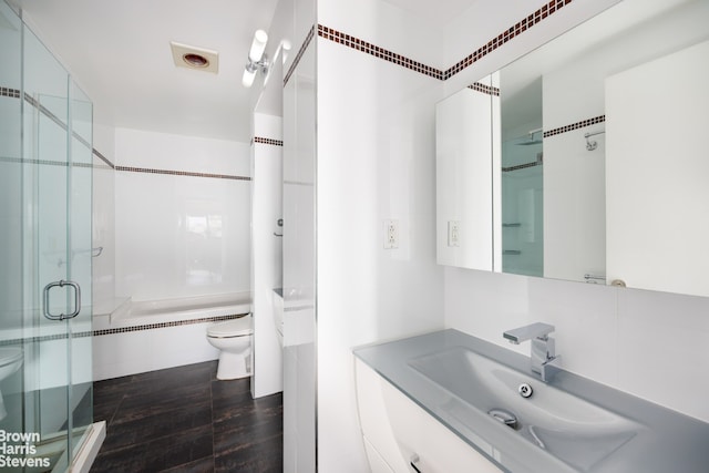 full bathroom with a bathing tub, a shower stall, toilet, and vanity