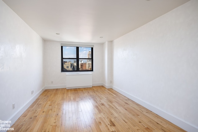 empty room featuring light wood-style flooring and baseboards