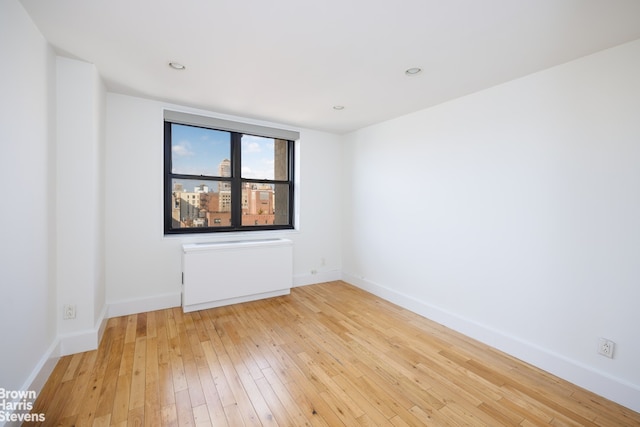 unfurnished room featuring recessed lighting, baseboards, and hardwood / wood-style flooring