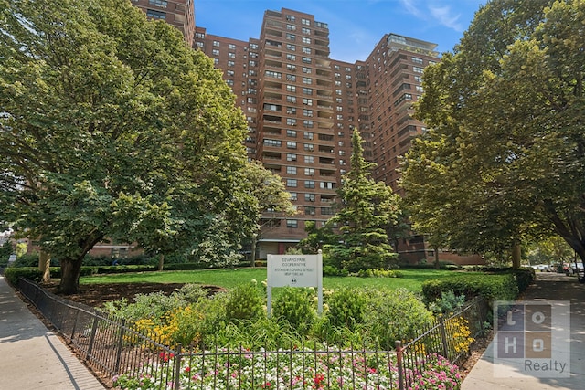 exterior space featuring a view of city and fence