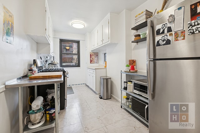 kitchen featuring marble finish floor, white cabinetry, stainless steel appliances, and open shelves