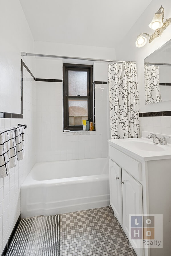 full bathroom featuring tile patterned floors, tile walls, vanity, and shower / bathtub combination with curtain