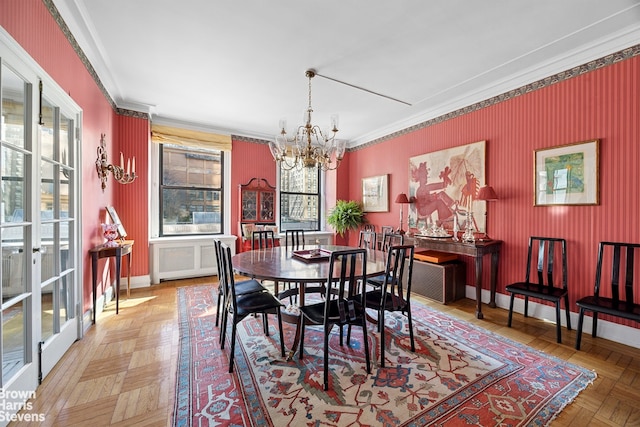 dining area featuring a notable chandelier, wallpapered walls, baseboards, and ornamental molding